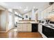 Bright kitchen showcases hardwood floors, white cabinets, and modern appliances at 13362 Marion St, Thornton, CO 80241