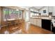 Inviting kitchen with hardwood floors, modern appliances, and a cozy breakfast nook at 13362 Marion St, Thornton, CO 80241