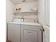 Convenient laundry room featuring a stacked washer and dryer for efficient space saving at 13362 Marion St, Thornton, CO 80241