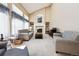 Inviting living room features vaulted ceilings, large windows, and a cozy fireplace at 13362 Marion St, Thornton, CO 80241