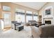 Comfortable living room with large windows, vaulted ceiling, and cozy fireplace at 13362 Marion St, Thornton, CO 80241