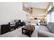 Open-concept living room boasts vaulted ceilings and seamless flow to the adjacent kitchen at 13362 Marion St, Thornton, CO 80241