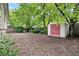 View of home's backyard with newly exposed soil, shed and mature trees at 204 Maple St, Frederick, CO 80530