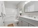 Bright bathroom boasts gray vanity, tub and shower, with neutral walls and fixtures at 204 Maple St, Frederick, CO 80530