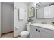 Bathroom with white vanity, framed mirror, and tiled shower with glass door at 204 Maple St, Frederick, CO 80530