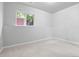 A well-lit bedroom with white walls and neutral carpet provides a blank canvas at 204 Maple St, Frederick, CO 80530