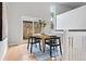 Bright dining area features hardwood floors, sliding glass doors to backyard, and modern decor at 204 Maple St, Frederick, CO 80530