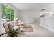 Sunlit living room with neutral walls and carpet with modern furnishings at 204 Maple St, Frederick, CO 80530