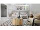 Bright living room featuring modern decor, a staircase, and a view of the dining area above at 204 Maple St, Frederick, CO 80530