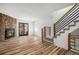 Living room with wood floors, stone fireplace, and modern staircase at 2935 W 81St Ave # H, Westminster, CO 80031