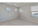 The bedroom offers carpeted floors, a neutral color palette, and multiple windows allowing natural light to fill the space at 48230 Shetland Dr, Bennett, CO 80102
