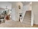 Open staircase leading to the upper level, adjacent to the living room and kitchen at 4785 S Estes St, Littleton, CO 80123