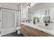 Modern bathroom with double vanity, white subway tile, and a tub shower at 3580 W 62Nd Pl, Denver, CO 80221