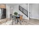 Bright dining area with modern table and chairs, stylish rug, and view of staircase at 3580 W 62Nd Pl, Denver, CO 80221