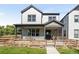 Two-story home with modern farmhouse exterior and landscaped yard at 3580 W 62Nd Pl, Denver, CO 80221