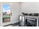 Bright laundry room with washer, dryer, and exterior access at 3580 W 62Nd Pl, Denver, CO 80221