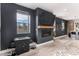 Living room with modern fireplace, game table, and wall-mounted TV at 3580 W 62Nd Pl, Denver, CO 80221