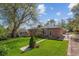 Brick house with large backyard, lawn, landscaping, shed, and mature trees at 6882 Moore St, Arvada, CO 80004