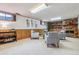 Finished basement featuring brick fireplace, carpet, and neutral colored furniture at 6882 Moore St, Arvada, CO 80004