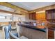 Basement bar features brick accents, wood paneling, and seating at 6882 Moore St, Arvada, CO 80004
