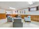 Finished basement featuring carpet, wood paneling, and neutral colored furniture at 6882 Moore St, Arvada, CO 80004
