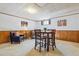 Finished basement featuring carpet, wood paneling, furniture and bar seating at 6882 Moore St, Arvada, CO 80004