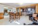 Finished basement area with wood paneling, bar area, and table with seating at 6882 Moore St, Arvada, CO 80004