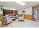 Finished basement featuring brick fireplace, carpet, and neutral colored furniture at 6882 Moore St, Arvada, CO 80004