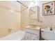 Bright bathroom with ceramic tiles, a marble sink, and a framed mirror at 6882 Moore St, Arvada, CO 80004