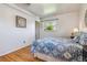 Bright bedroom featuring hardwood floors, soft lighting, and tasteful decor at 6882 Moore St, Arvada, CO 80004