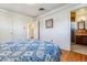 A well lit bedroom with hardwood floors and an attached bathroom space at 6882 Moore St, Arvada, CO 80004