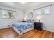 Comfortable bedroom with hardwood floors, ample natural light, and decorative accents at 6882 Moore St, Arvada, CO 80004