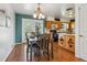 Dining room featuring wood floors, table with chairs, and backyard access at 6882 Moore St, Arvada, CO 80004