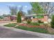 Charming ranch-style home with a brick exterior, a well-manicured lawn, and mature trees at 6882 Moore St, Arvada, CO 80004