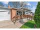 Front of the house showing a brick facade, a covered porch, and a well-kept lawn at 6882 Moore St, Arvada, CO 80004