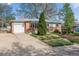 Charming ranch style home with brick accents, a well-manicured lawn, and a driveway at 6882 Moore St, Arvada, CO 80004