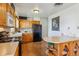Well-lit kitchen with wooden cabinets, black appliances, and ample counter space at 6882 Moore St, Arvada, CO 80004