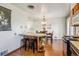 Open view of kitchen, island seating area, and adjacent dining room at 6882 Moore St, Arvada, CO 80004