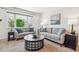 Bright living room featuring neutral walls, comfortable seating, and a large window at 6882 Moore St, Arvada, CO 80004