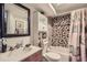 Cozy bathroom with a unique tiled shower/tub and updated vanity at 7310 Carnation Pl, Commerce City, CO 80022