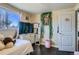 A bedroom featuring hardwood floors, a window and natural light at 7310 Carnation Pl, Commerce City, CO 80022