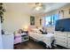 Bright bedroom with a ceiling fan, plush bedding, and a sunlit window at 7310 Carnation Pl, Commerce City, CO 80022