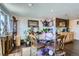 Charming dining area with seating for four, dark floors, and delightful celebratory decorations at 7310 Carnation Pl, Commerce City, CO 80022