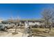 Charming single story home with stone accents, well-manicured lawn, and inviting front entrance at 7310 Carnation Pl, Commerce City, CO 80022