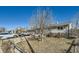 Landscaped front yard with mature trees and charming stone accents highlight this single story home at 7310 Carnation Pl, Commerce City, CO 80022