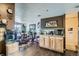 Open-concept kitchen and dining area with light wooden cabinets and dark laminate flooring at 7310 Carnation Pl, Commerce City, CO 80022