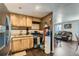 Functional kitchen featuring stainless steel appliances, wooden cabinets, and dark laminate flooring at 7310 Carnation Pl, Commerce City, CO 80022