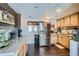 Kitchen featuring stainless steel appliances, wood cabinets, laminate floors, and ample counter space at 7310 Carnation Pl, Commerce City, CO 80022