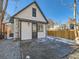 Back exterior showing a white house with a gray door and concrete patio at 3120 N Race St, Denver, CO 80205