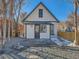 Back exterior of a white house with grey accents and a small patio at 3120 N Race St, Denver, CO 80205